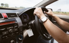 21993192 - male hands on steering wheel on the right with country side view