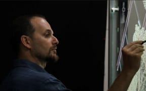 Andrew Millison using drawing to explain permaculture concepts in his popular YouTube videos.