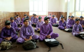 Afghan school boys attend their first class following the start of the new academic year, at a private school in Khost on March 20, 2024. Schools in Afghanistan opened for the new academic year on March 20, the education ministry said, with girls banned from joining secondary-level classes for the third year in a row. (Photo by AFP)