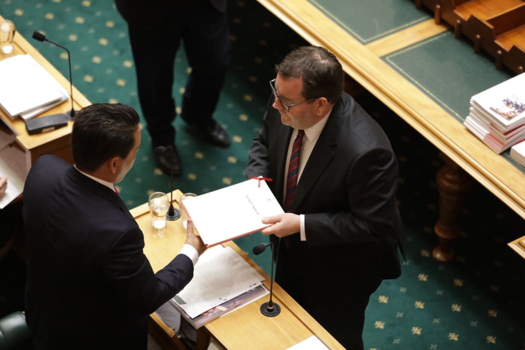 Finance Minister Grant Robertson hands the Budget Speech to National Party leader Simon Bridges.