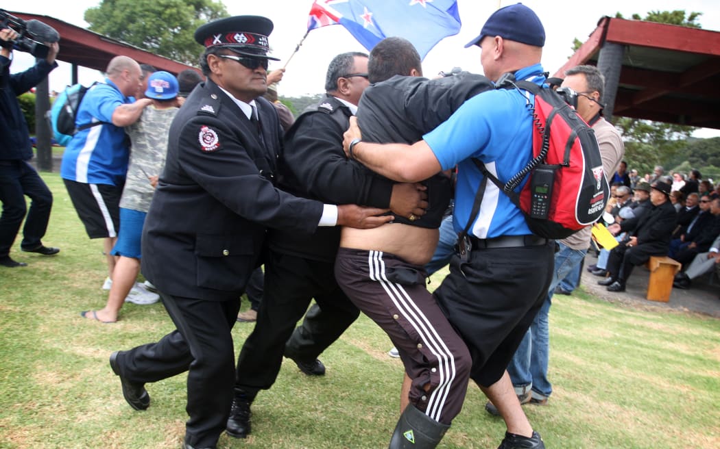 Protesters clash with Māori Wardens on the Te Tii Marae during the National Party's visit the day before Waitangi Day 2012.