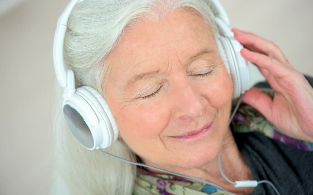 elderly woman with headphones