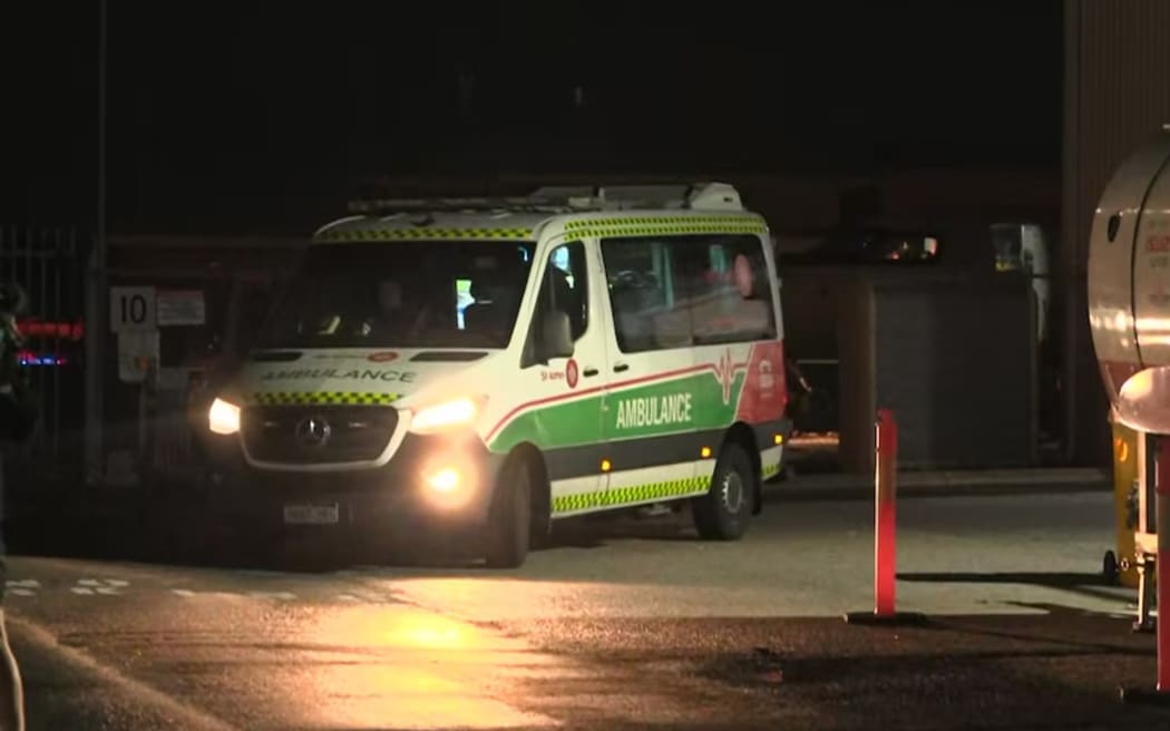 An ambulance driving at night.