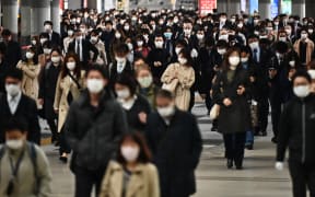 People commute to work despite a state of emergency in Japan at Shinagawa station in Tokyo on April 16, 2020.