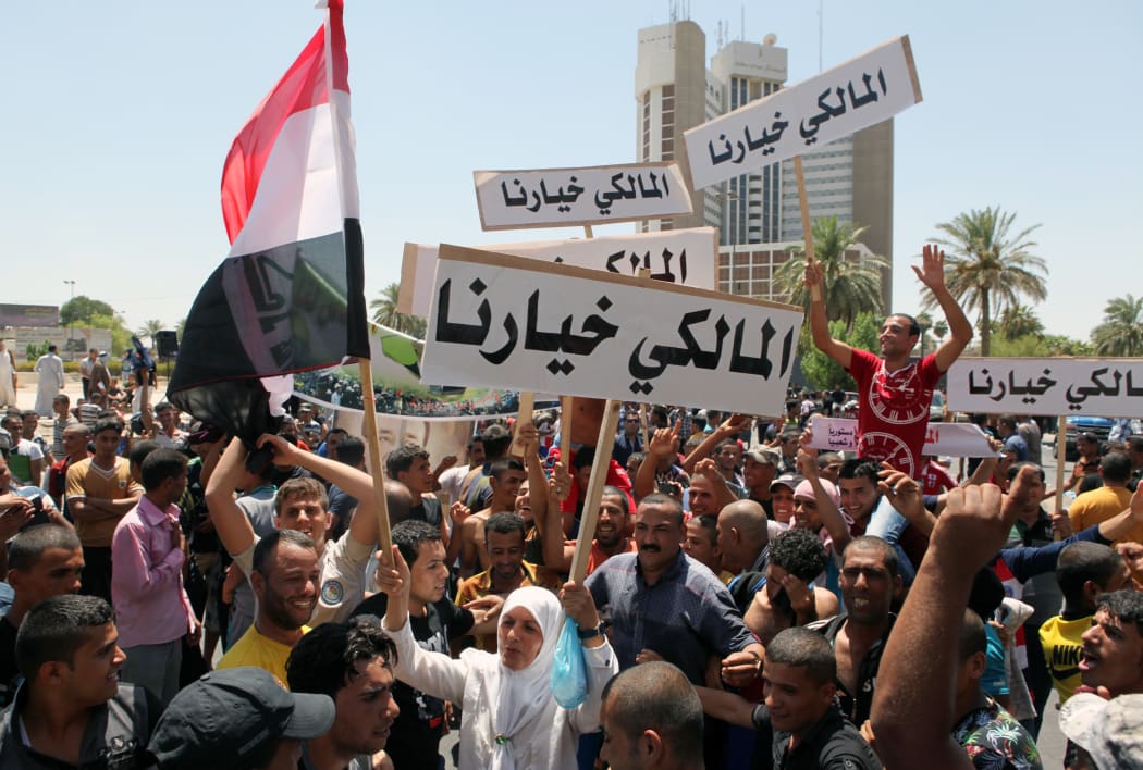 Demonstrators in Baghdad hold placards reading 'Maliki is our choice' in support of the veteran leader.
