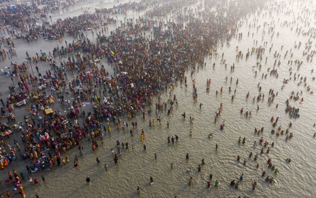 In this aerial photo taken on January 14, 2020, Hindu devotees gather to take a holy dip in the Bay of Bengal during the Gangasagar Mela, at Sagar Island, some 150 kilometres south of Kolkata.