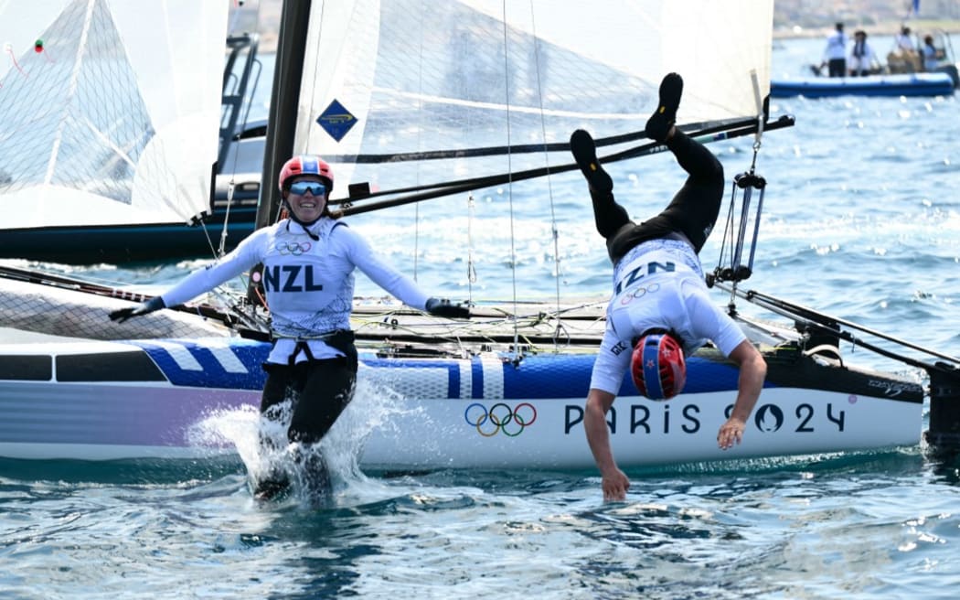 Bronze medallists New Zealand's Micah Wilkinson and Erica Dawson celebrate after the medal race of the mixed Nacra 17 multihull event during the Paris 2024 Olympic Games sailing competition at the Roucas-Blanc Marina in Marseille on August 8, 2024. (Photo by Christophe SIMON / AFP)