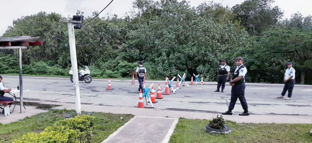 Fiji police man a checkpoint to enforce the lockdown