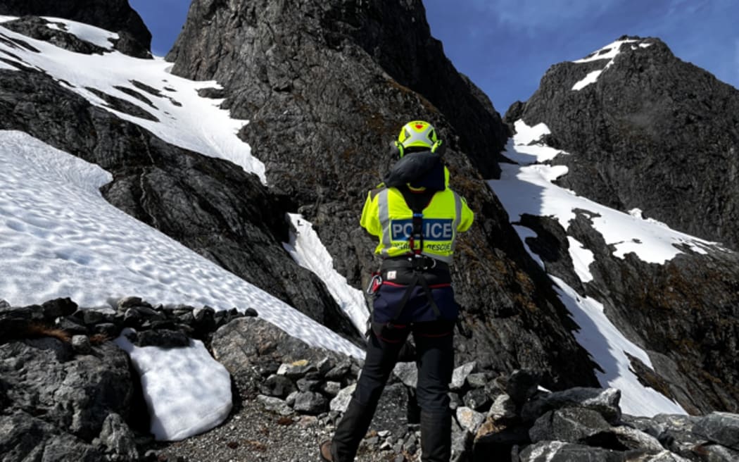 A police team member on a mountain in Fiordland.