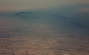 Smoke and haze over mountains seen from a No 11 Squadron P-8A Poseidon aircraft assessing damage in the area from bushfires, in Cooma in New South Wales.