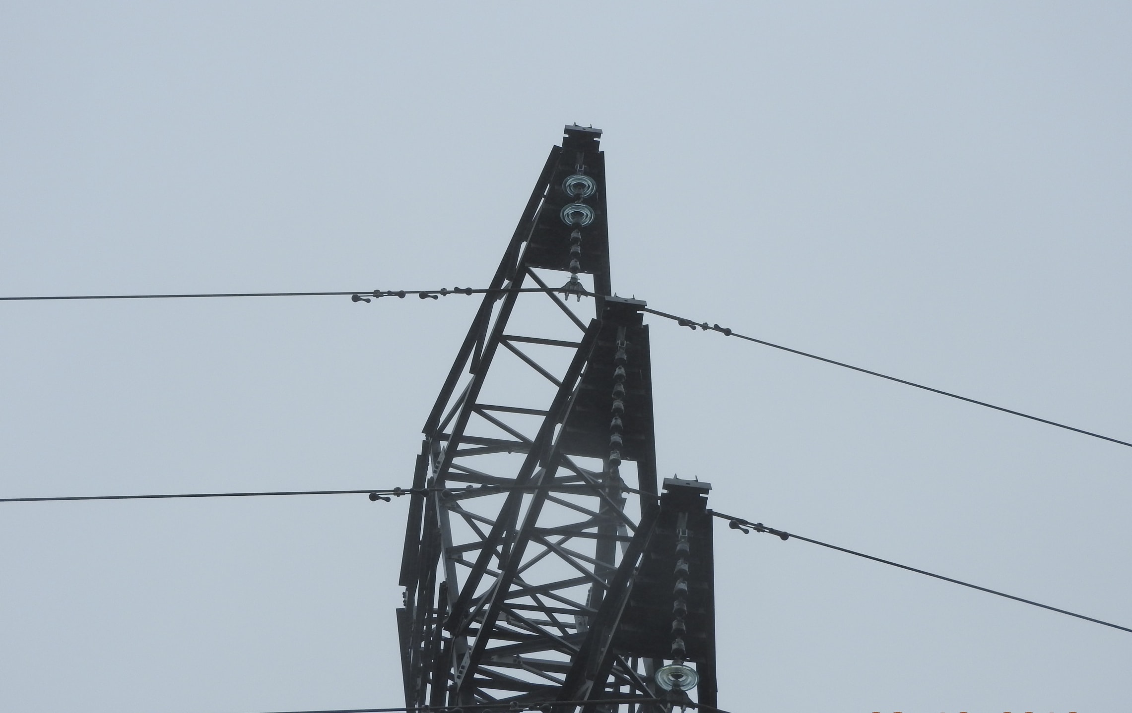 Three transmission towers have a number of their glass insulators damaged.