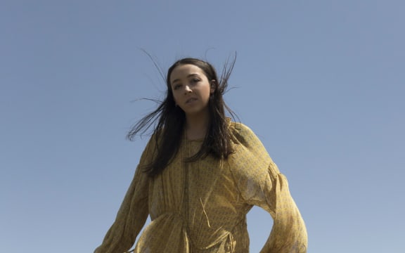 Young woman in a billowy yellow dress