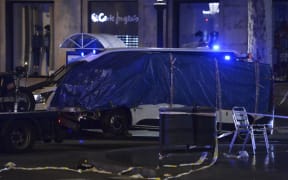 The van that was driven into the crowd, killing at least 13 people, is towed away from Las Ramblas in Barcelona