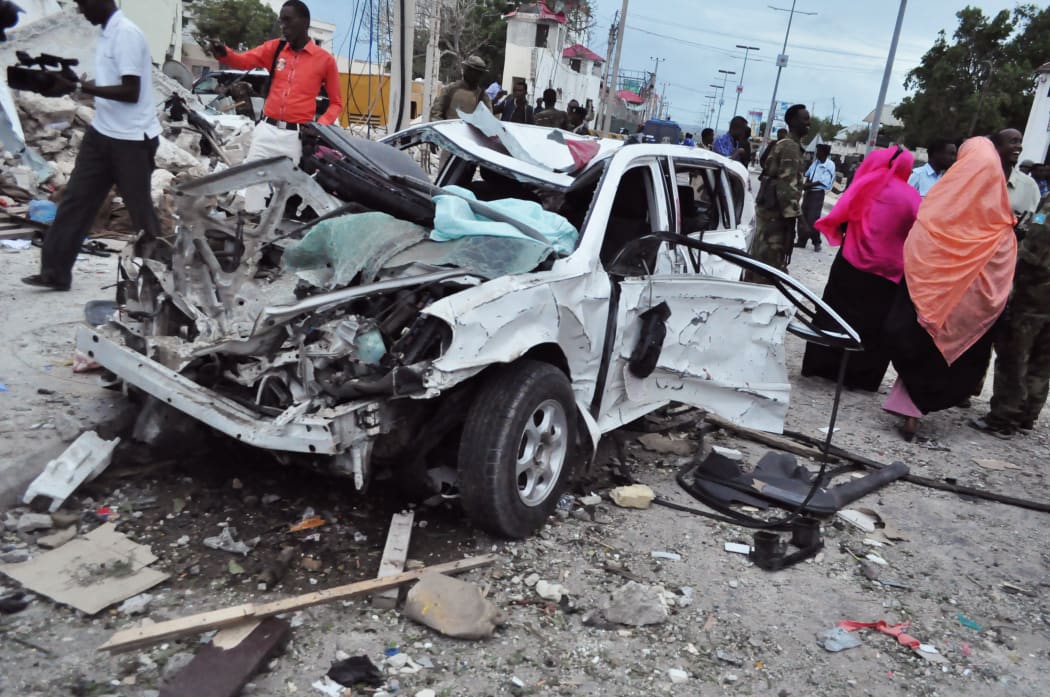 Damaged car at the scene of an explosion in Mogadishu, Somalia