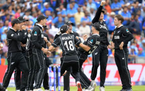 New Zealand's Martin Guptill (2R) celebrates with teammates after running out India's Mahendra Singh Dhoni for 50 during the 2019 Cricket World Cup first semi-final between New Zealand and India at Old Trafford in Manchester.