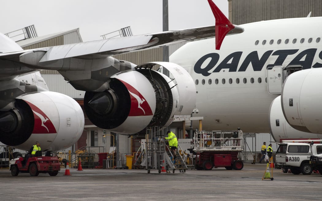 This picture taken on June 1, 2018 shows ground staff preparing a Qantas Airbus A380 aircraft for flight at the Sydney International airport.