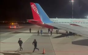 This frame grab taken from video footage posted on the Telegram channel @askrasul on October 29, 2023 shows protestors running on the apron area of an airport in Makhachkala. A mob looking for Israelis and Jews overran an airport in Russia's Caucasus republic of Dagestan on October 29, after rumours spread that a flight was arriving from Israel. (Photo by Telegram / @askrasul / AFP) /