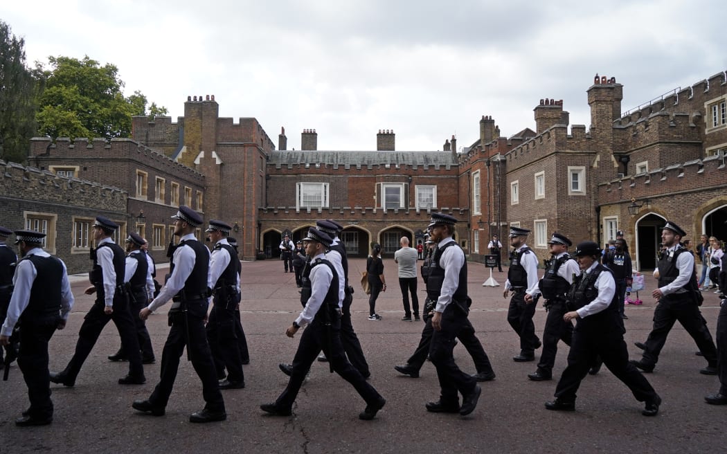 Police officers march past Friary Court at St James's Palace in London a day after Queen Elizabeth II died.