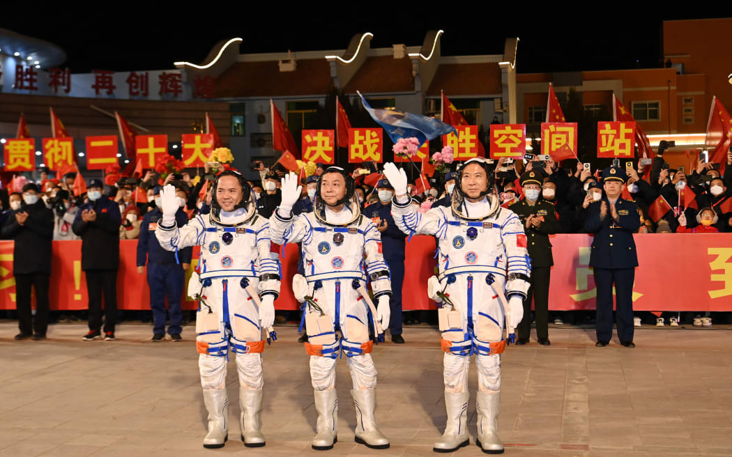 (From R) Chinese astronauts Fei Junlong, Deng Qingming and Zhang Lu, crew of the Shenzhou-15 spaceflight mission, wave during a ceremony prior to the launch of the Shenzhou-15 mission at the Jiuquan Satellite Launch Center in Northwest China’s Gansu Province on November 29, 2022. - China launched the Shenzhou-15 spacecraft on November 29, 2022 carrying three astronauts to its space station, where they will complete the country's first-ever crew handover in orbit, state news agency Xinhua reported.