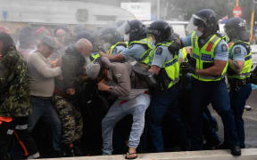 Police and protestors clash at the conclusion of an occupation at Parliament.