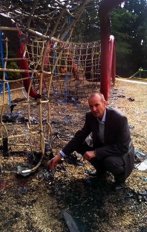 Mark Bruhn and the climbing apparatus destroyed in the fire.