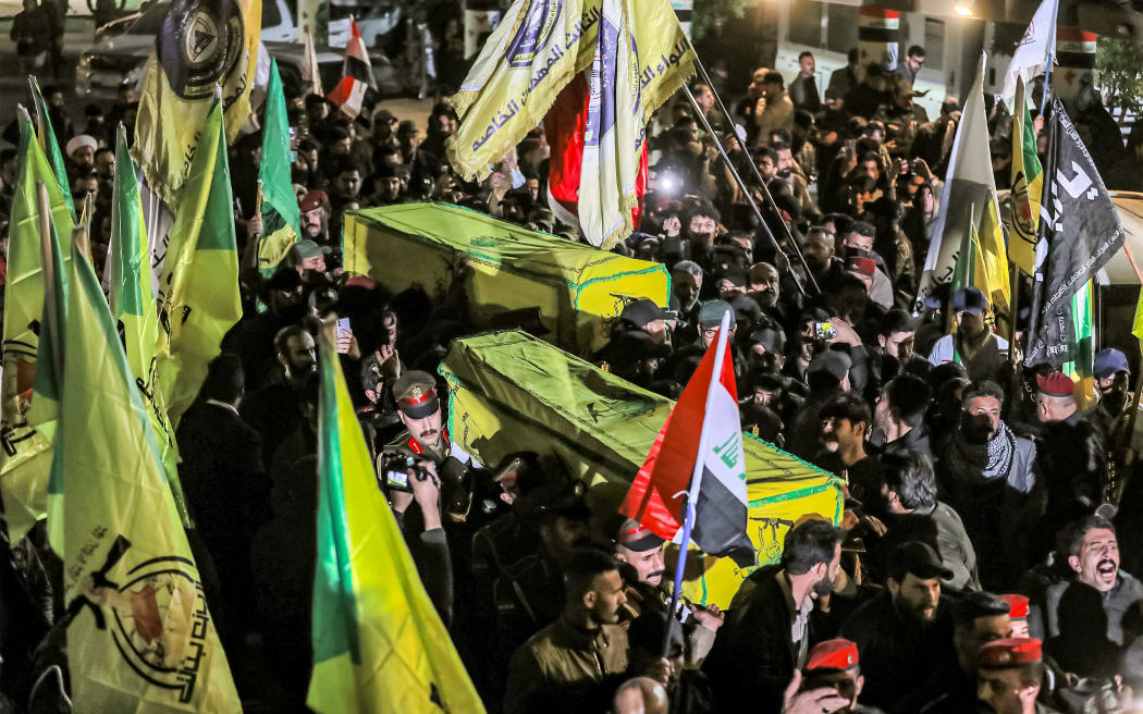 Members of Iraq's Popular Mobilisation Forces (PMF) paramilitaries carry the bodies of two of their slain comrades during their funeral at the PMF headquarters in Baghdad on January 4, 2024. A US strike in Baghdad on January 4 killed a military commander of the PMF, an ex-paramilitary faction of the grouping said, with an Iraqi security official reporting two deaths in a drone attack. Harakat al-Nujaba, one of the PMF's factions, said in a statement that "the deputy commander of operations for Baghdad, Mushtaq Talib al-Saidi", had been "martyred in a US strike".