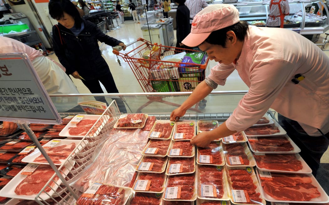 A South Korean employee displays local beef at a Lotte Mart - NZ exporters may start losing sales.