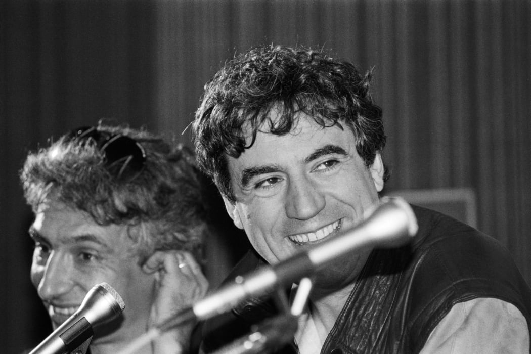 Monty Python star and film director Terry Jones, right, speaks to meda about his film "The Meaning of Life" at the Cannes film festival, 1983.