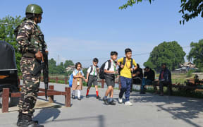 Schoolchildren walk to school in Srinagar on May 13, 2025, as schools reopen following the India-Pakistan ceasefire. (Photo by Basit Zargar / Middle east images / Middle East Images via AFP)