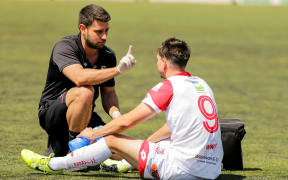 Waitakere United's Dane Schnell is checked for concussion.