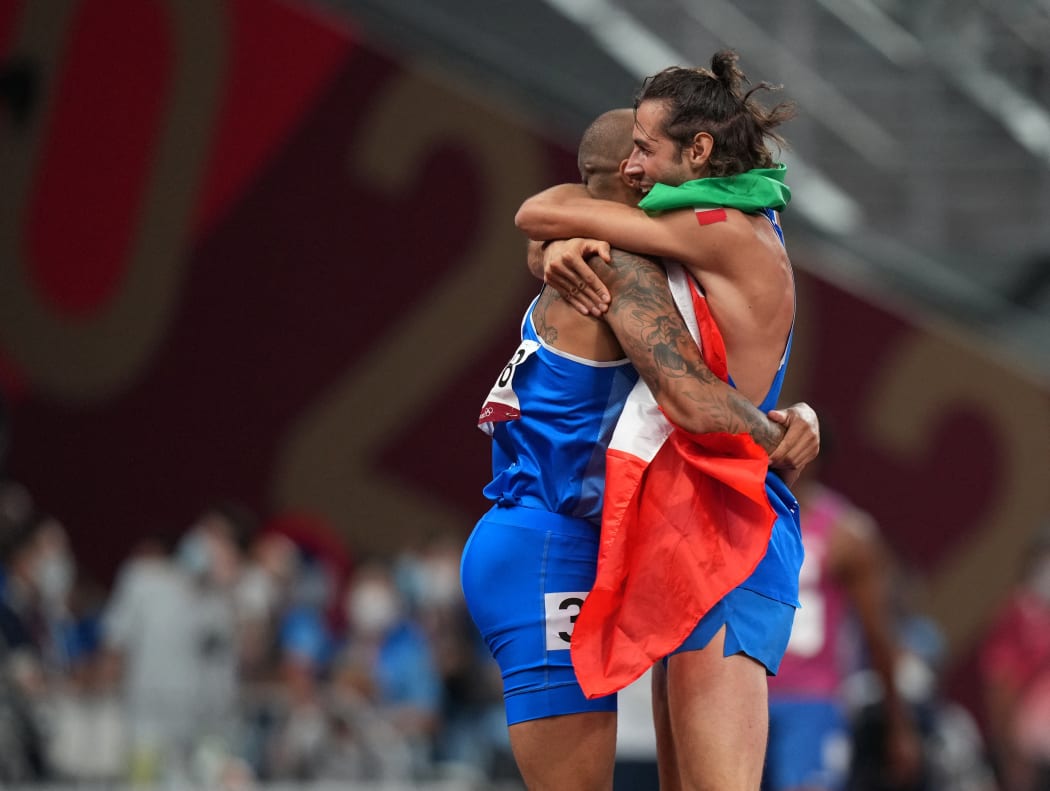 Italy's Lamont Marcell Jacobs, left, and Gianmarco Tamberi celebrate their Olympic gold medals.