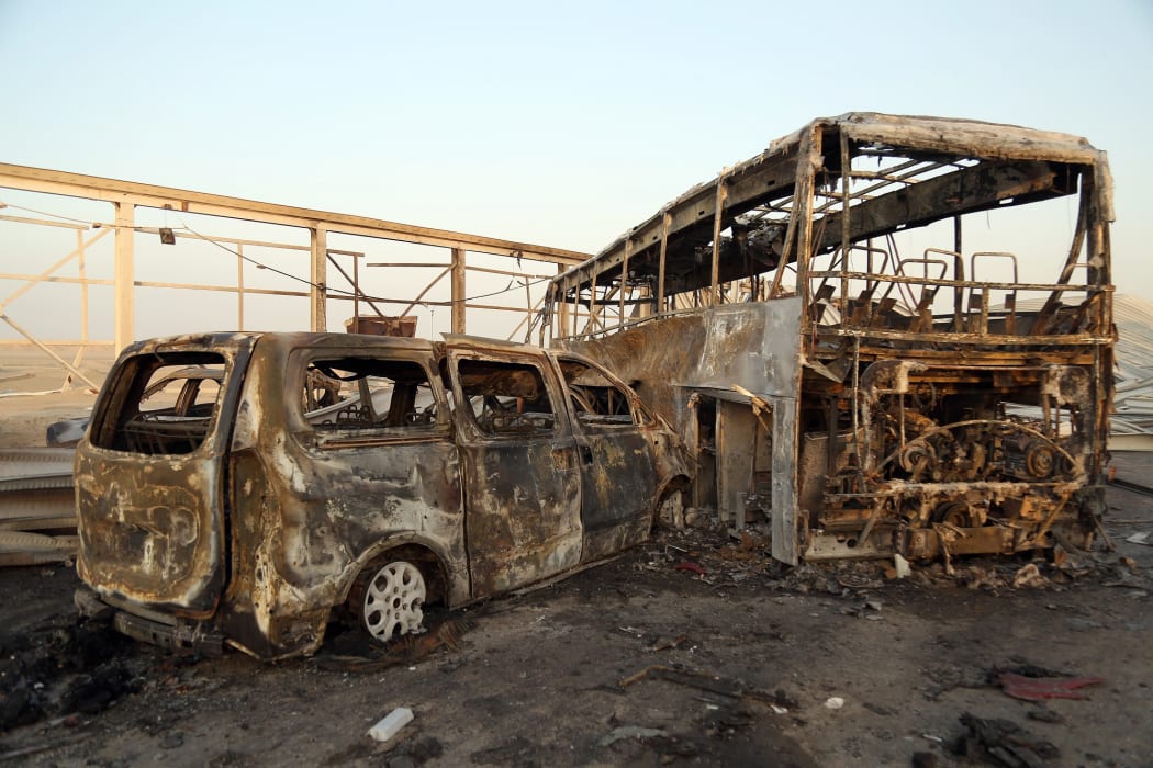 A general view show burnt out vehicles after gunmen and suicide car bombers killed dozens of people in two assaults claimed by Islamic State (IS) group jihadists near the southern Iraqi city of Nasiriyah on September 14, 2017.