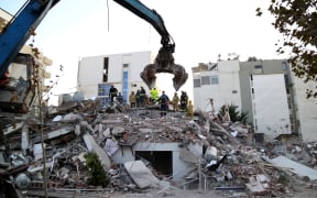 Emergency workers look for survivors trough the rubble of a damaged building in the coastal city of Durres, west of capital Tirana, after an earthquake hit Albania, on November 26, 2019.