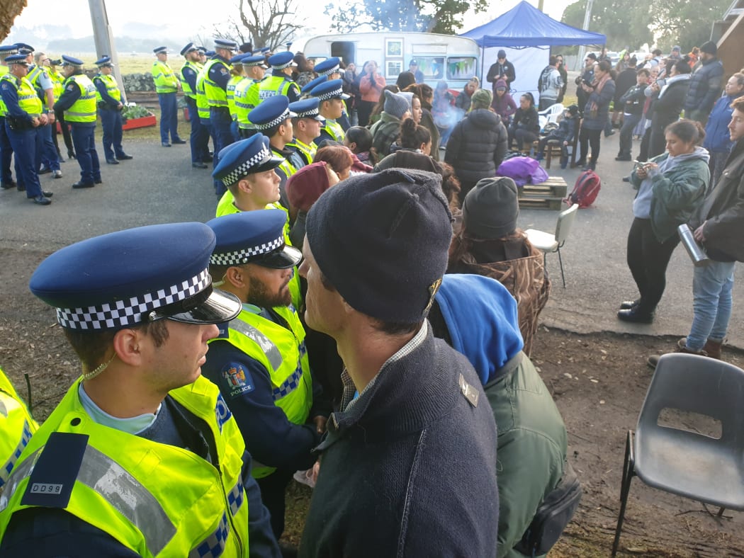 Police and some protesters at the site today.