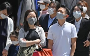 People wearing face masks are seen at Ginza district in Chuo Ward, Tokyo on April 20, 2021, amid a pandemic of the new coronavirus COVID-19.