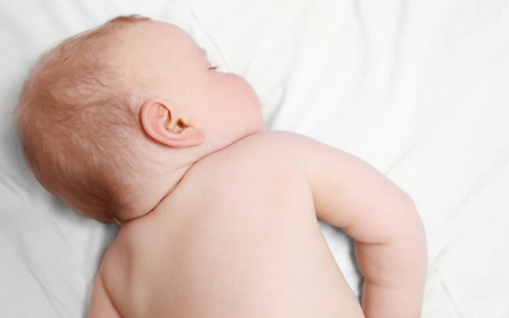 Peaceful baby sleeping in a bed, close up