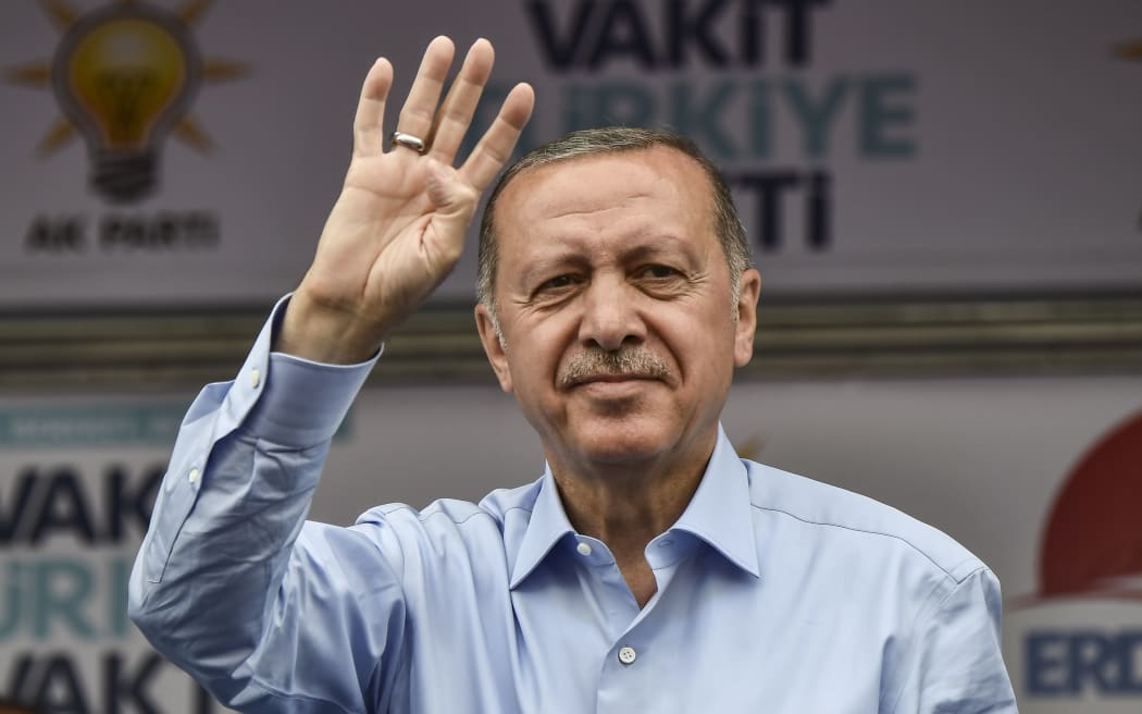Turkish outgoing President and candidate Recep Tayyip Erdogan salutes party supporters during a rally on the eve of the elections in Istanbul.