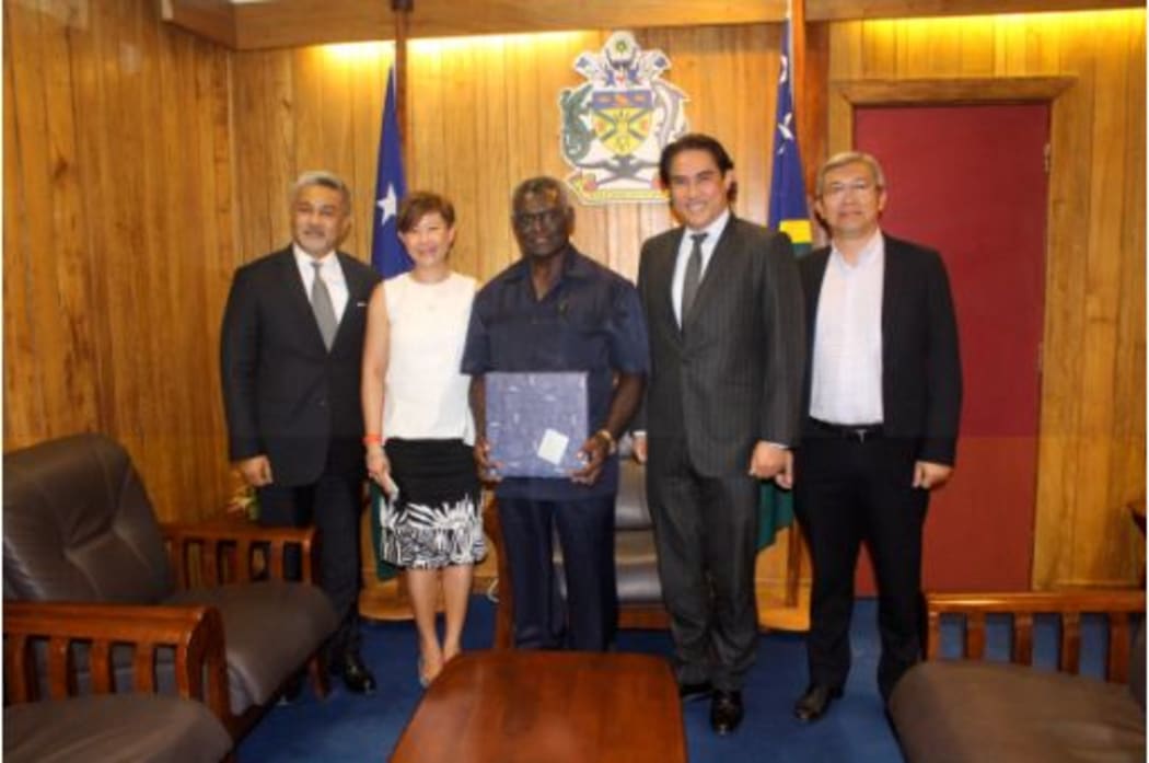 Solomon Islands Prime Minister Manasseh Sogavare (middle) with representatives of Crimson Petroleum.