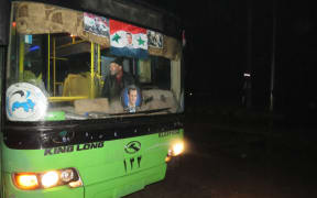A bus which will be used to evacuate civilians leaving from rebel-held areas of Aleppo is seen on 13 December, 2016.