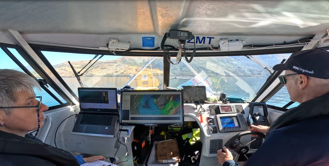 Lake Wānaka mapping project team onboard RV Rukuwai II with multibeam echosounder attached to the bow of the research vessel.