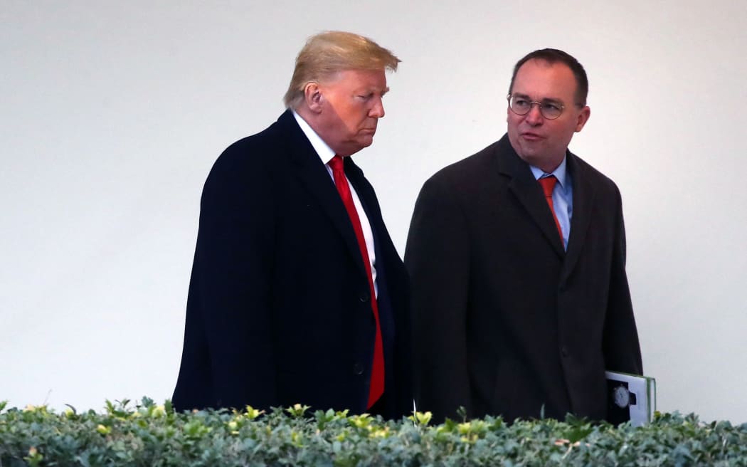 US President Donald Trump walks along the West Wing Colonnade with acting White House chief of staff, Mick Mulvaney in January 13, 2020 in Washington, DC.