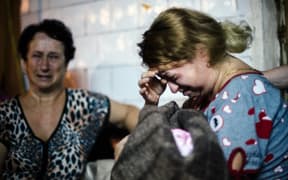 A mother with her newborn baby cries inside a bomb shelter during shelling in Donetsk at the weekend.