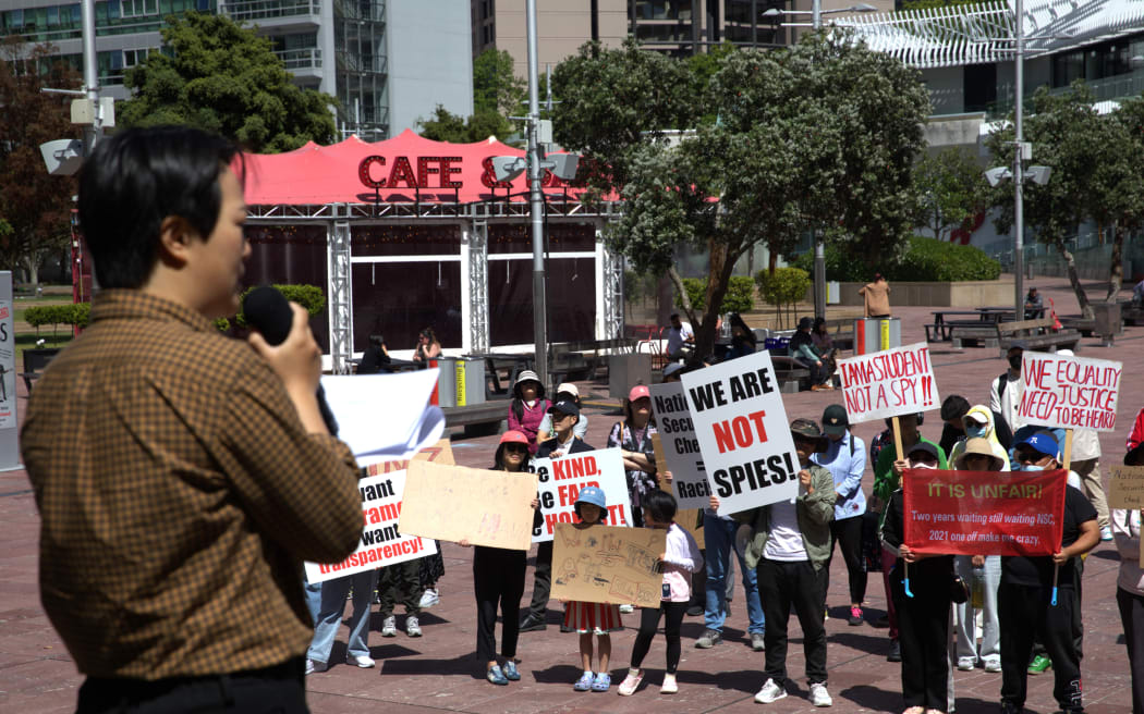 Hundreds of Chinese took to Auckland's Queen St on Sunday (12 November, 2023) to protest against National Security Check delays their Resident Visa applications.