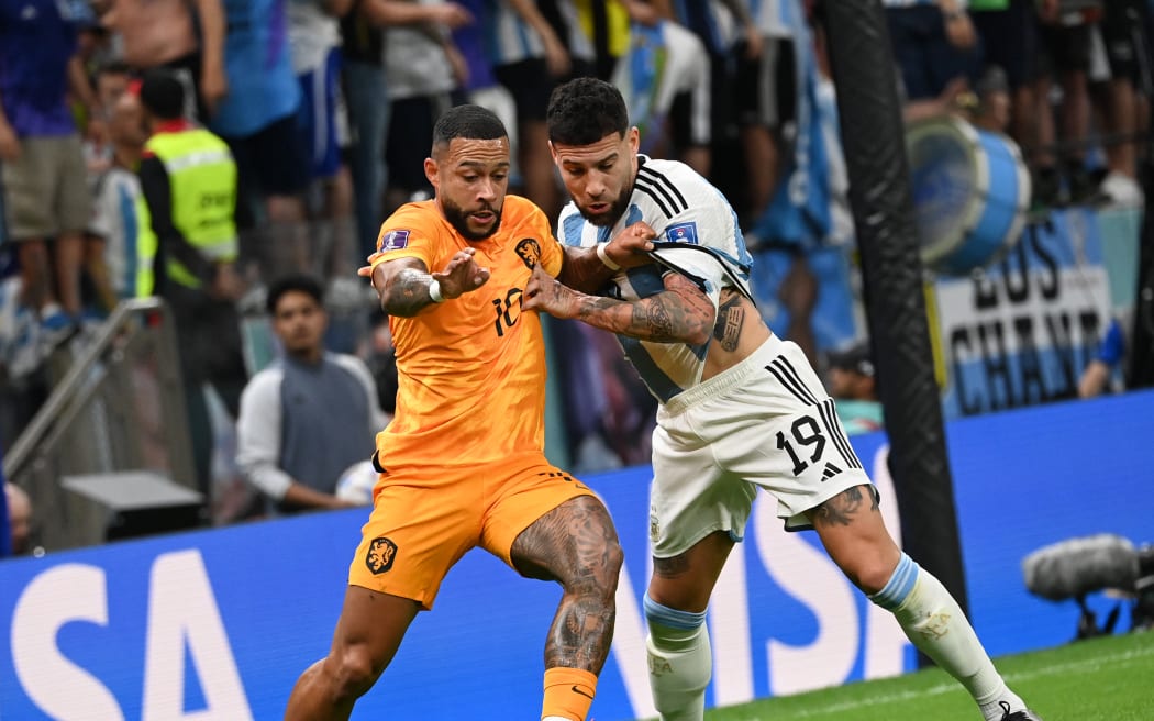 Nicolas Otamendi of Argentina and Memphis Depay of Netherlands struggle to hold a ball in the first half during the FIFA World Cup quarter-final match Netherlands vs Argentina at Lusail Stadium in Al Daayen, Qatar on December 9, 2022.