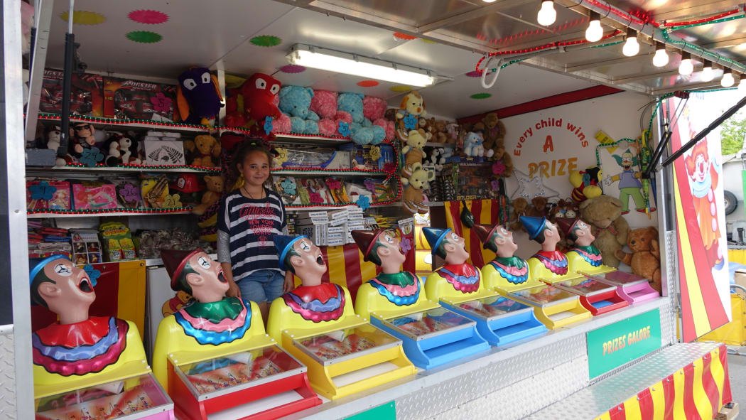 Georgia Avery helps out her dad, Jason, at his concession stand at the Canterbury A& P show.