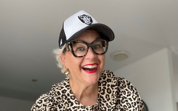 Auckland personal stylist Emma John, wearing a leopard print top, bum bag worn as across-body bag and a black and white cap.