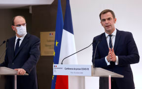 French Health Minister Olivier Veran (right) speaks flanked by French Prime Minister Jean Castex  during a press conference on 15 October to present the details of new restrictions aimed at curbing the spread of the Covid-19 pandemic.