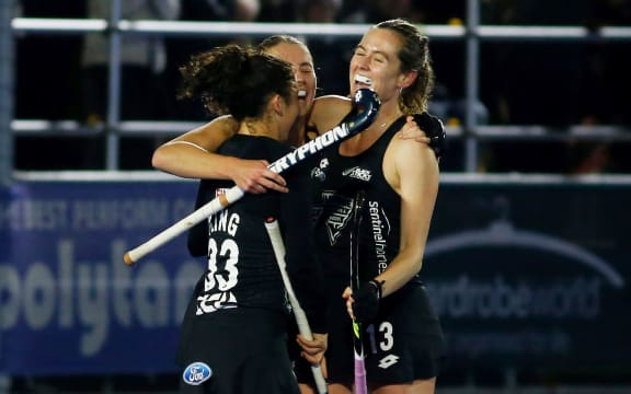 Julia King, Olivia Shannon and Samantha Charlton celebrate a goal.