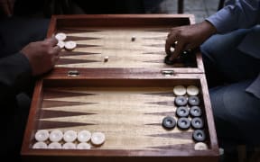 TO GO WITH AFP STORY
Egyptians play backgammon at a cafe in Cairo on November 24, 2014. Six months after Abdel Fattah al-Sisi became Egypt's president a deadly crackdown on Islamist supporters of Sisi's predecessor Mohamed Morsi, whom he ousted last year has generated a climate of fear at train and bus stations, public squares and cafes, activists say. AFP PHOTO / MOHAMED EL-SHAHED (Photo by MOHAMED EL-SHAHED / AFP)