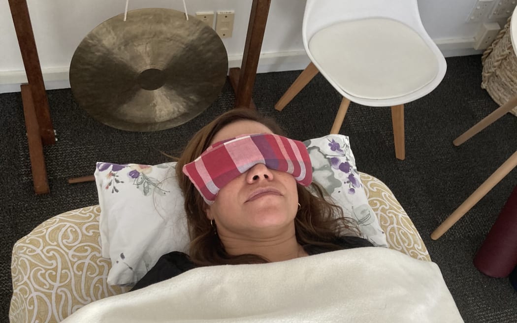 Stacey Morrison laying down for a sound healing session
